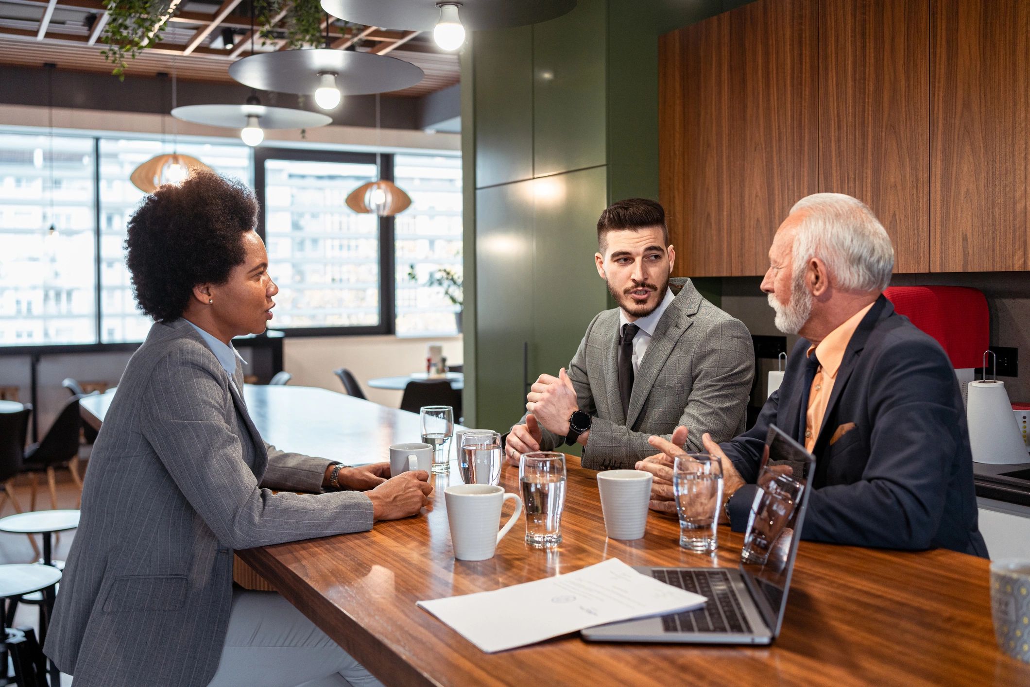 Multiracial professionals talking during a coffee break