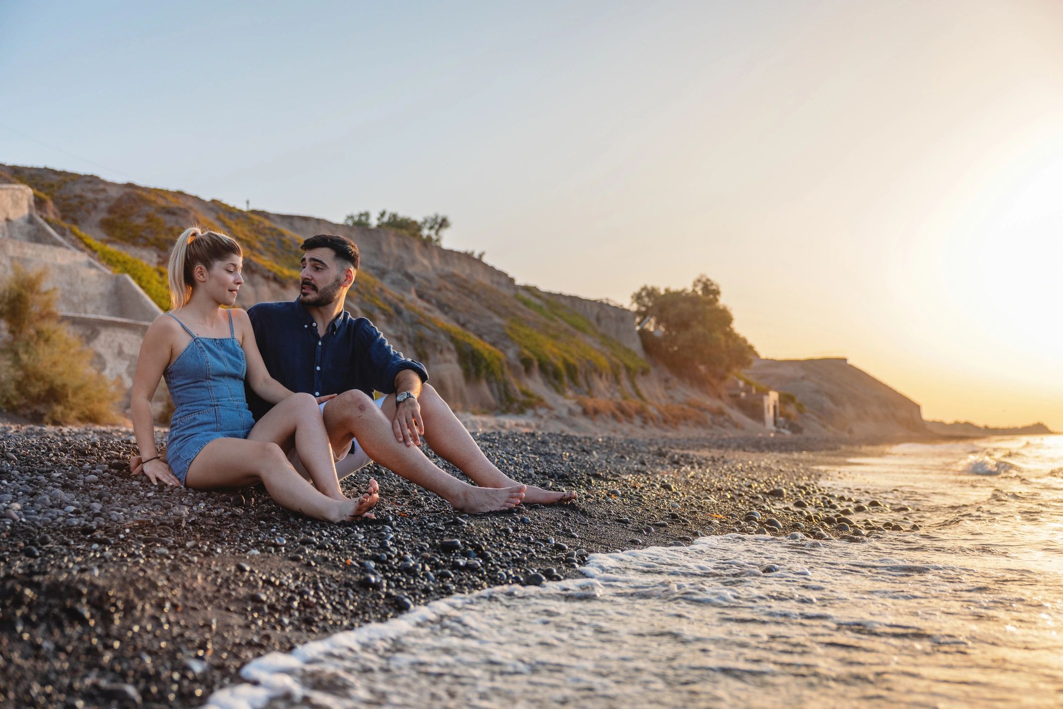 Couple enjoying a sunset on a Santorini beach