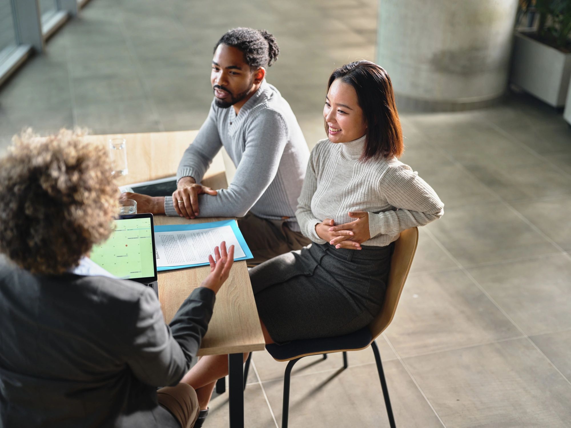 Couple meeting with an advisor in a modern office