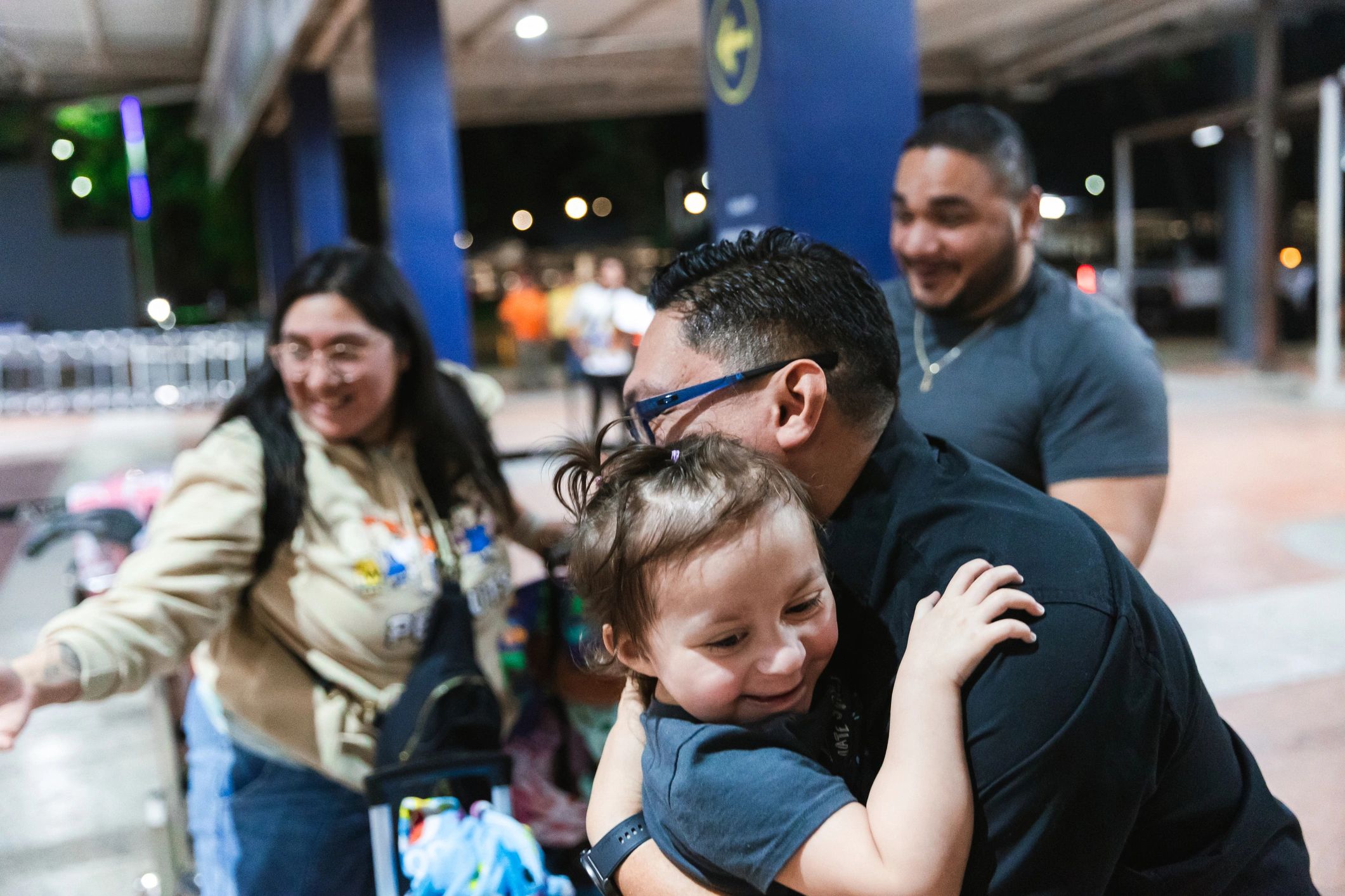 Family reunion moment outside an airport terminal