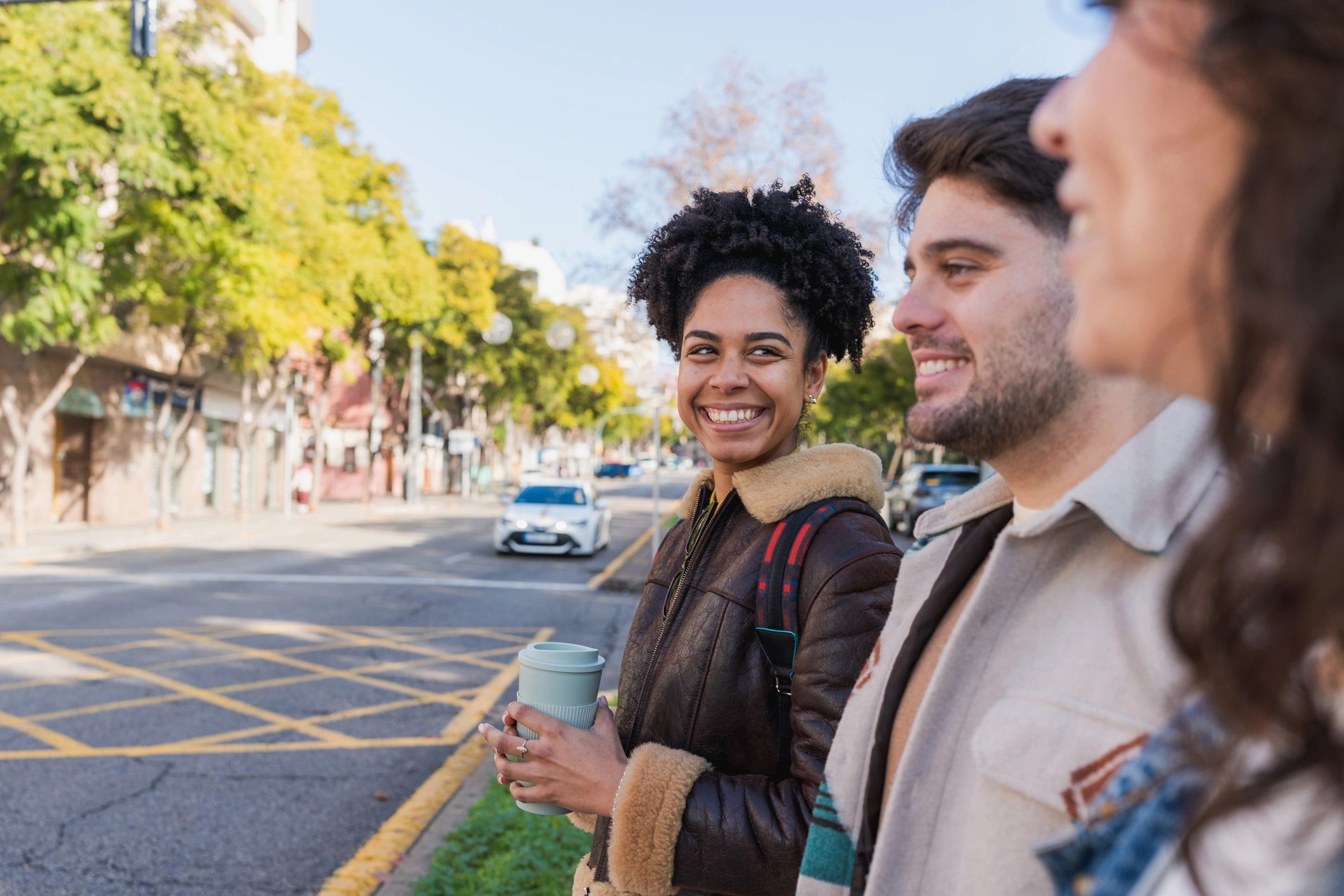 Diverse friends walking and talking in a city